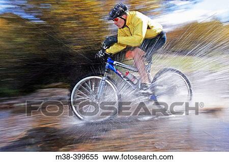 Man splashing through water on a mt. biking in Sun Valley, Idaho. USA View Large Photo Image Stock Photography - Man splashing through water on a mt. biking in Sun Valley, Idaho. USA. Fotosearch