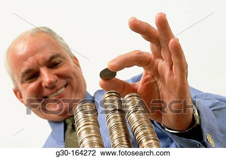 Man stacking coins View Large Photo Image Stock Image - Man stacking coins. Fotosearch