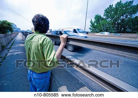 Man standing beside a highway. View Large Photo Image Stock Photography - Man standing beside a highway.. Fotosearch