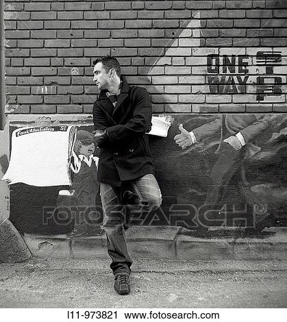 Man standing in alley; with a newspaper. View Large Photo Image Stock Image - Man standing in alley; with a newspaper.. Fotosearch