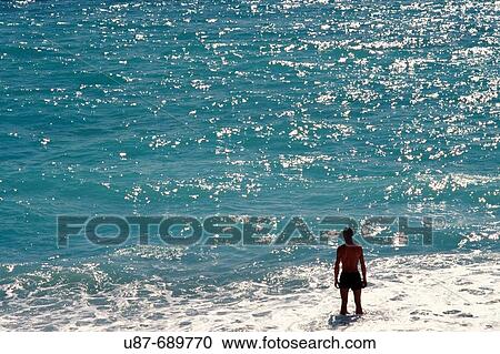 Man standing in sea. Nice. C? te d? Azur. France. View Large Photo Image Stock Image - Man standing in sea. Nice. C? te d? Azur. France.. Fotosearch