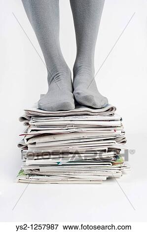 Man standing on a pile of old newspapers, Recycling View Large Photo Image Stock Photo - Man standing on a pile of old newspapers, Recycling. Fotosearch