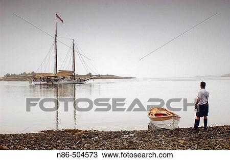 Man standing on shore and boats. Maine, USA View Large Photo Image Stock Image - Man standing on shore and boats. Maine, USA. Fotosearch
