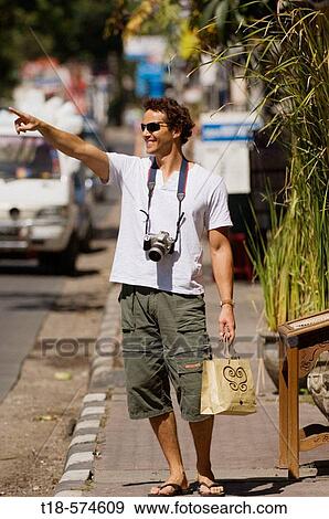 man standing on sidewalk and pointing View Large Photo Image Stock Photo - man standing on sidewalk and pointing. Fotosearch