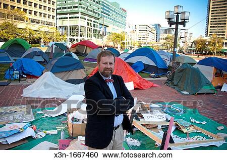 Man stands in jest against occupy movement tents in Baltimore Maryland USA View Large Photo Image Stock Image - Man stands in jest against occupy movement tents in Baltimore Maryland USA. Fotosearch