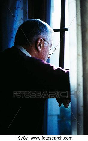 Man stares out a window View Large Photo Image Stock Photo - Man stares out a window. Fotosearch