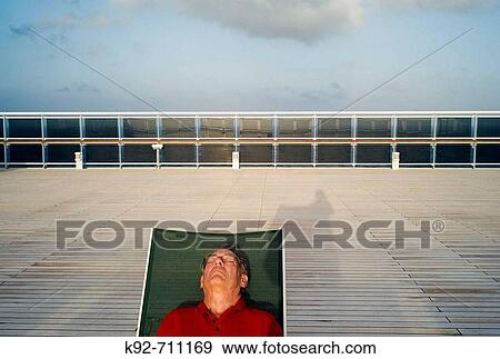Man sunbathing on the deck of a cruise ship. View Large Photo Image Stock Photo - Man sunbathing on the deck of a cruise ship.. Fotosearch