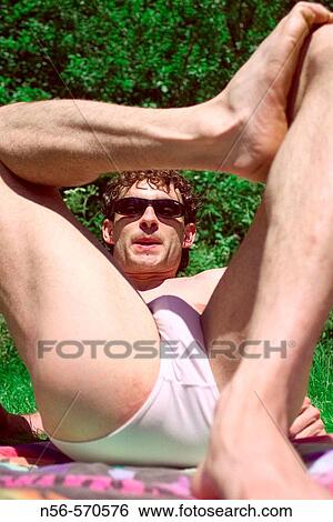 Stock Photograph - Man sunbathing. Fotosearch