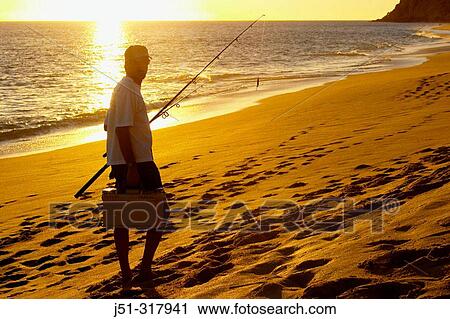 Man surfcast at Playa Solmar, walk with tackle box and pole on sandy beach, barefoot. Cabo San Lucas. Mexico View Large Photo Image Stock Image - Man surfcast at Playa Solmar, walk with tackle box and pole on sandy beach, barefoot. Cabo San Lucas. Mexico. Fotosearch