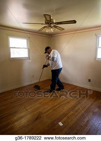 Man sweeps floor in empty-room inside of a foreclosed home in Warwick, Rhode Island View Large Photo Image Stock Image - Man sweeps floor in empty-room inside of a foreclosed home in Warwick, Rhode Island. Fotosearch