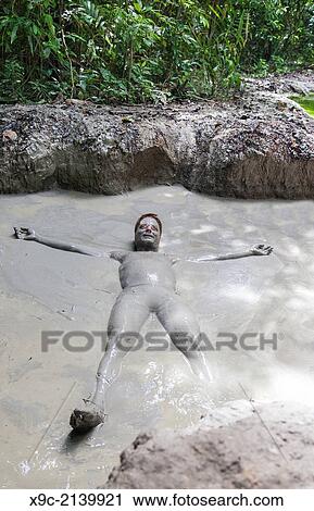 Man Taking a Bath at Mud Volcano on Tiga Island, Borneo, Malaysia. View Large Photo Image Stock Image - Man Taking a Bath at Mud Volcano on Tiga Island, Borneo, Malaysia.. Fotosearch