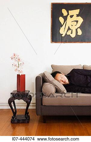 Man taking nap in apartment with Asian decor. Paris. France View Large Photo Image Picture - Man taking nap in apartment with Asian decor. Paris. France. Fotosearch