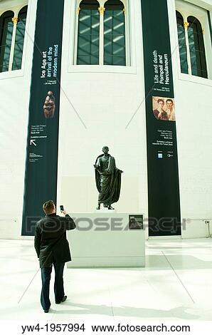 Man taking photo with mobile phone, Great Court, British Museum, London, UK. View Large Photo Image Picture - Man taking photo with mobile phone, Great Court, British Museum, London, UK.. Fotosearch