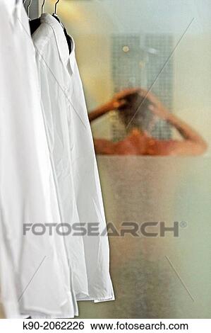 Man taking shower while business shirts are readily available. View Large Photo Image Stock Photograph - Man taking shower while business shirts are readily available.. Fotosearch