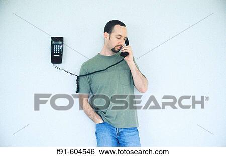 Man talking on phone View Large Photo Image Stock Photograph - Man talking on phone. Fotosearch