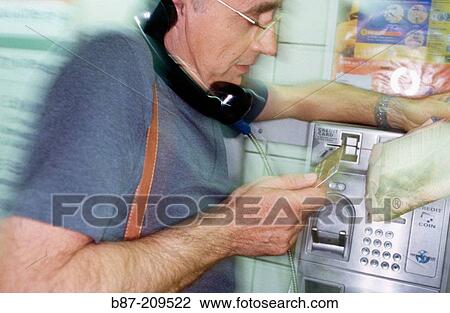 Man talking on public phone View Large Photo Image Stock Image - Man talking on public phone. Fotosearch