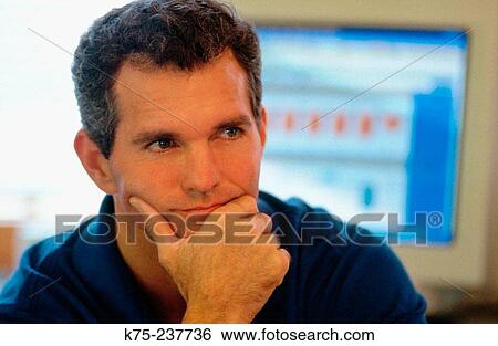 Stock Photograph - Man thinking at his computer. Fotosearch