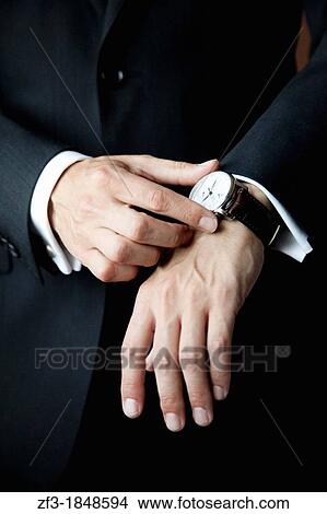 Man touching his watch View Large Photo Image Picture - Man touching his watch. Fotosearch