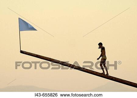 Man trying to reach the flag as a target. View Large Photo Image Stock Photograph - Man trying to reach the flag as a target.. Fotosearch