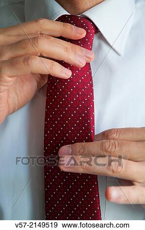 Man tying his tie. Close view. View Large Photo Image Stock Photo - Man tying his tie. Close view.. Fotosearch