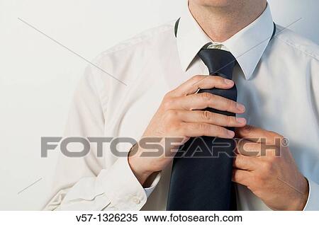 Man tying his tie. Close view. View Large Photo Image Stock Photography - Man tying his tie. Close view.. Fotosearch