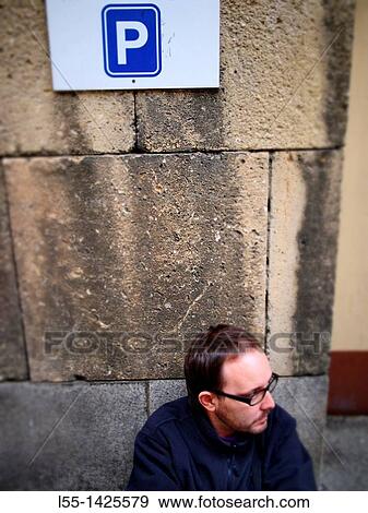 Stock Photo - Man under parking sign. Fotosearch