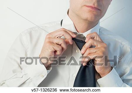 Man untying his tie. Close view. View Large Photo Image Stock Photograph - Man untying his tie. Close view.. Fotosearch