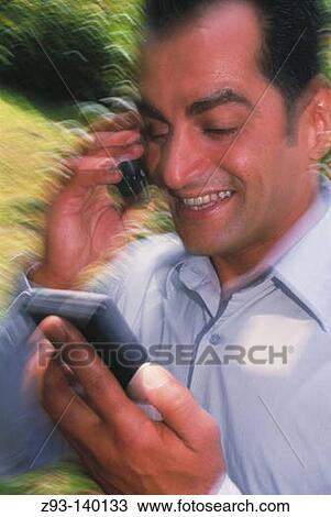 Stock Image - Man using a PDA. Fotosearch