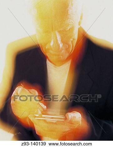 Man using a Personal Digital Assistant View Large Photo Image Stock Photo - Man using a Personal Digital Assistant. Fotosearch