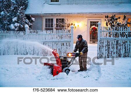 Man using a snowblower to clear walk View Large Photo Image Picture - Man using a snowblower to clear walk. Fotosearch