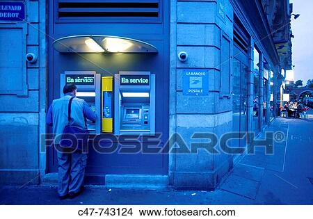Man using ATM, Paris, France View Large Photo Image Picture - Man using ATM, Paris, France. Fotosearch