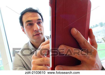 Stock Image - Man using digital tablet. Fotosearch