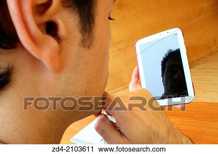 Stock Image - Man using digital tablet. Fotosearch