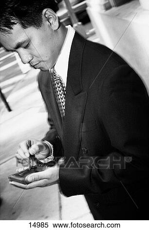 Man using electronic organizer View Large Photo Image Stock Photography - Man using electronic organizer. Fotosearch