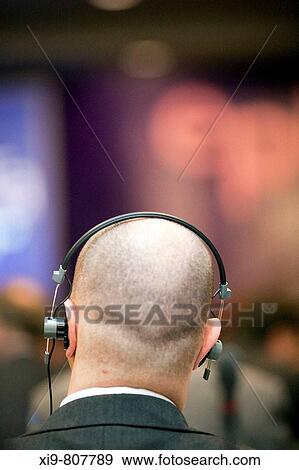 Man using headphones in conference hall, Dublin, Ireland View Large Photo Image Stock Photo - Man using headphones in conference hall, Dublin, Ireland. Fotosearch