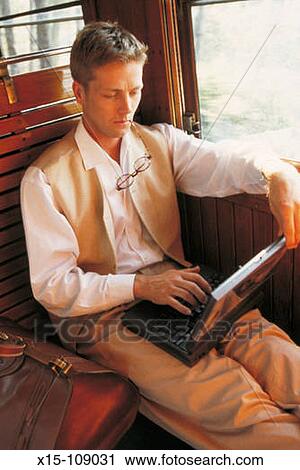 Man using laptop computer View Large Photo Image Stock Image - Man using laptop computer. Fotosearch