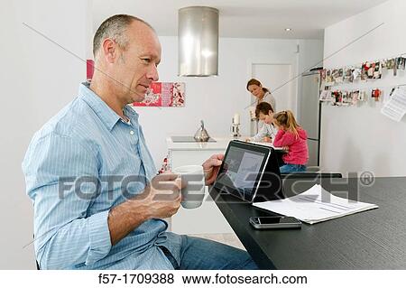 Man using tablet computer at home View Large Photo Image Stock Photo - Man using tablet computer at home. Fotosearch