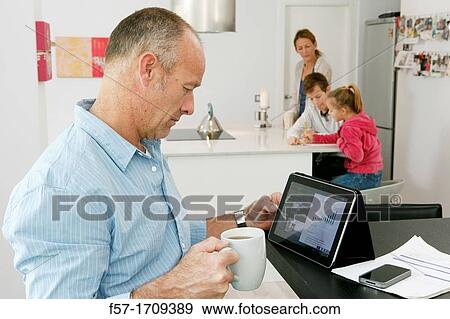 Man using tablet computer at home View Large Photo Image Stock Photo - Man using tablet computer at home. Fotosearch