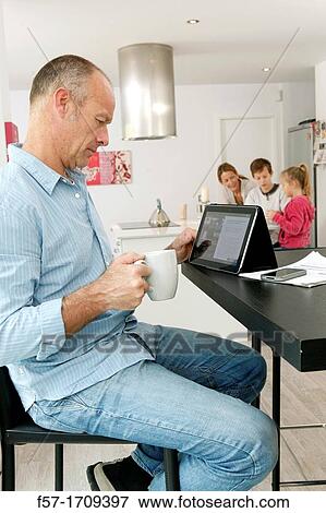 Man using tablet computer at home View Large Photo Image Stock Photo - Man using tablet computer at home. Fotosearch