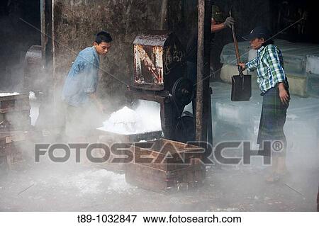 Stock Photo - Man waiting for crash Ice for the fish market. Fotosearch