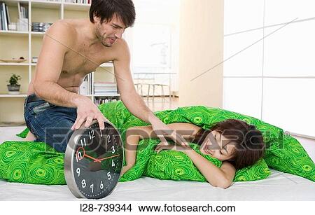 Picture - man waking up woman. Fotosearch