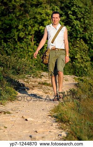 Stock Image - Man walking a track in Russian National Park? Samara Luka?. Fotosearch