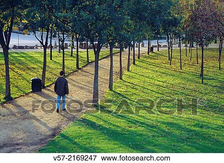 Man walking along a path in La Fuencisla gardens. Segovia, Castilla Leon, Spain. View Large Photo Image Stock Photo - Man walking along a path in La Fuencisla gardens. Segovia, Castilla Leon, Spain.. Fotosearch