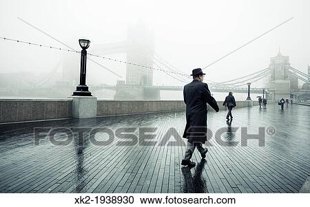 Man walking along Thames path towards Toward Bridge in a foggy rainy day, London, UK View Large Photo Image Stock Image - Man walking along Thames path towards Toward Bridge in a foggy rainy day, London, UK. Fotosearch