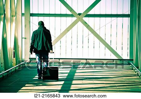 Man walking back with a wheeled suitcase. Airport, El Prat de Llobregat, Barcelona, Catalonia, Spain. View Large Photo Image Stock Image - Man walking back with a wheeled suitcase. Airport, El Prat de Llobregat, Barcelona, Catalonia, Spain.. Fotosearch