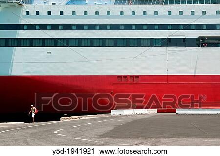 man walking in harbour of Heraklion next to huge cruise ship, Greece, Europe View Large Photo Image Stock Image - man walking in harbour of Heraklion next to huge cruise ship, Greece, Europe. Fotosearch