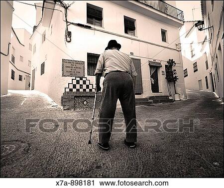 Man walking in the street, Istan. Malaga province, Andalusia, Spain View Large Photo Image Stock Image - Man walking in the street, Istan. Malaga province, Andalusia, Spain. Fotosearch