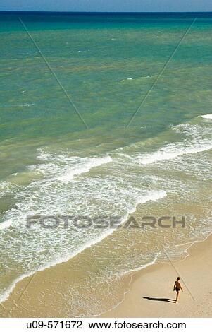 Man walking on Mil Palmeras beach. Alicante province. Spain. View Large Photo Image Stock Image - Man walking on Mil Palmeras beach. Alicante province. Spain.. Fotosearch