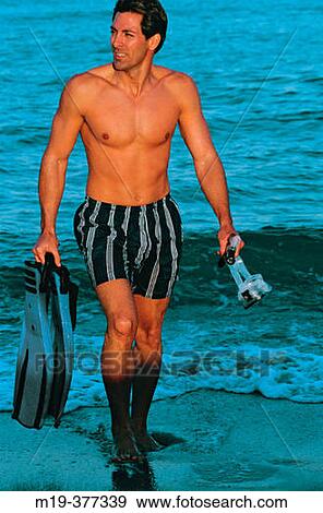 man walking on the beach with snorkling gear View Large Photo Image Stock Photo - man walking on the beach with snorkling gear. Fotosearch