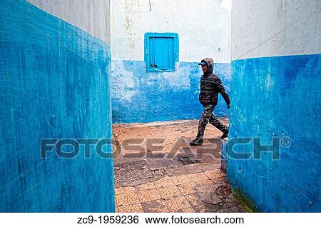 Man walking on the blue streets of Larache medina, Morocco. View Large Photo Image Stock Photograph - Man walking on the blue streets of Larache medina, Morocco.. Fotosearch